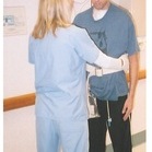 A few weeks after waking up from the coma, trying to walk